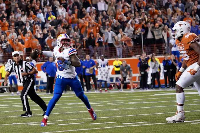 Nov 13, 2021; Austin, Texas, USA; Kansas Jayhawks quarterback Jalon Daniels (6) looks for a receiver to complete the game winning two point conversion against the Texas Longhorns in overtime at Darrell K Royal-Texas Memorial Stadium. Mandatory Credit: Scott Wachter-USA TODAY Sports